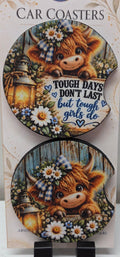 Actual photo of two Highland cow neoprene car coasters with finger notches, one with Tough Days Don't Last but Tough Girls Do lettering