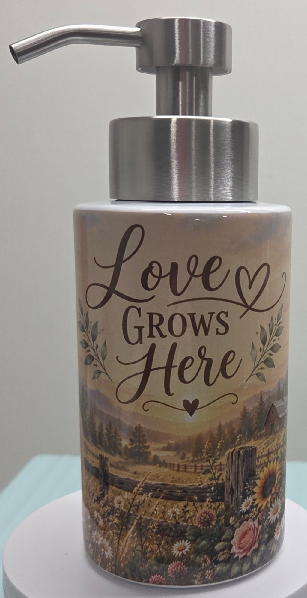 Actual dispenser showing the words Love Grows Here and rustic meadow design