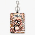 Sprinkle Joy Wherever You Waddle penguin ID holder on white background with upright silver key ring and clasp